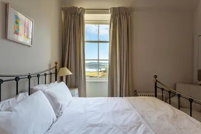 a bedroom with a bed and a large window at Tarbert Country Manor in Tarbert