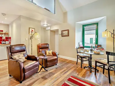 a living room with leather chairs and a table at 1 Bed in Dunning oc-ca333 in Dunning
