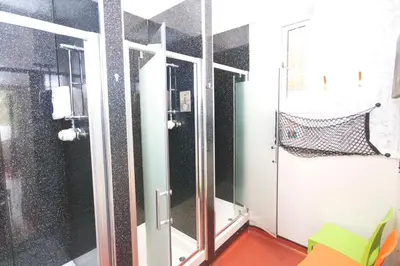 a bathroom with a shower and a glass door at Blackwater Glamping Pods in Kinlochleven