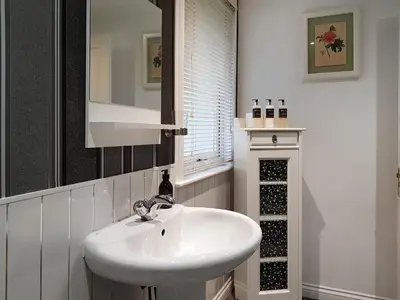 a bathroom with a white sink and a wine rack at Leven Lodge 2 - Uk46044 in Balloch