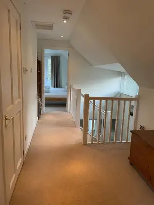 an empty hallway with a staircase in a house at The Cottage, overlooking Loch Fyne in Cairndow