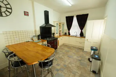 a kitchen with a wooden table and a stove at Saskatchewan House in Oban