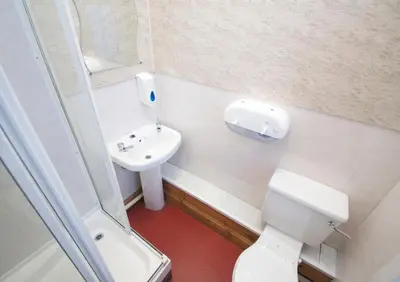 a small bathroom with a toilet and a sink at Blackwater Hostel in Kinlochleven
