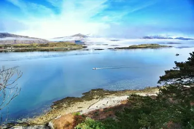 a large body of water with a boat in it at The Airds Hotel and Restaurant in Port Appin