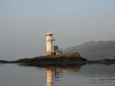 a lighthouse on an island in the water at The Airds Hotel and Restaurant in Port Appin