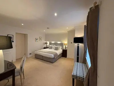 a bedroom with a bed and a desk and a bed sidx sidx sidx at The Airds Hotel and Restaurant in Port Appin