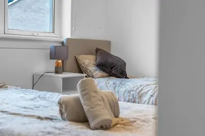 a bedroom with a bed and a window at West Lothian 5 Beds + car space in Whitburn