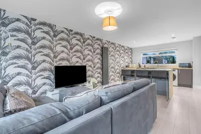 a living room with a couch and a television at West Lothian 5 Beds + car space in Whitburn