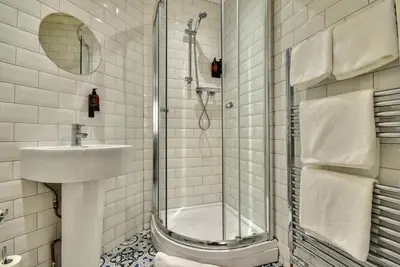 a bathroom with a shower and a sink at Exclusive Use in Gourock