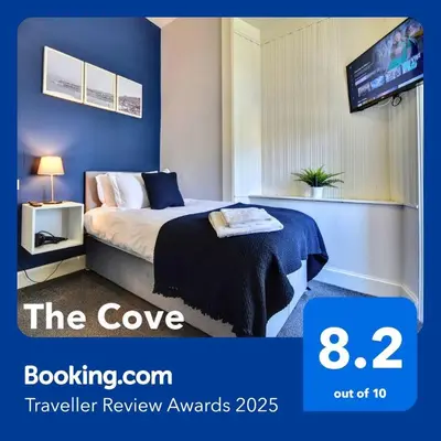 a hotel room with a bed and a tv at The Cove in Gourock