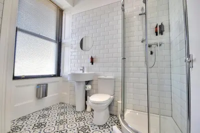 a bathroom with a toilet and a sink and a shower at The Cloch in Gourock