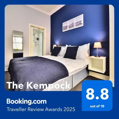 a bedroom with a king sized bed with blue walls at The Kempock in Gourock