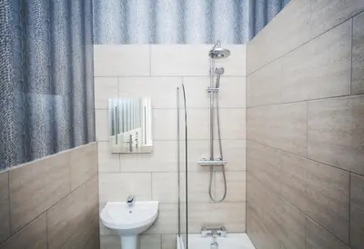 a bathroom with a shower and a toilet and a sink at Braid Hills Hotel in Edinburgh