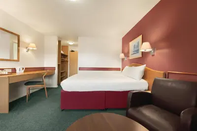 a hotel room with a bed and a desk at Days Inn Hotel Abington - Glasgow in Abington