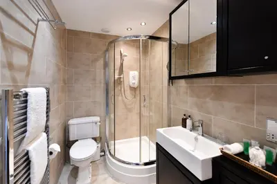 a bathroom with a shower and a toilet and a sink at The Townhouse Ayr - Luxury B&B - adults only in Ayr