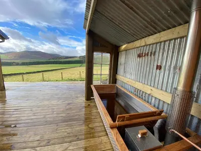 a wooden porch of a building with a view of a field at Townhead in Peebles