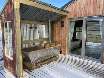 a screened in porch with a bench on a deck at Townhead in Peebles