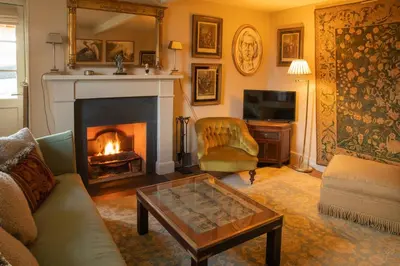 a living room with a fireplace and a couch at Townhead in Peebles