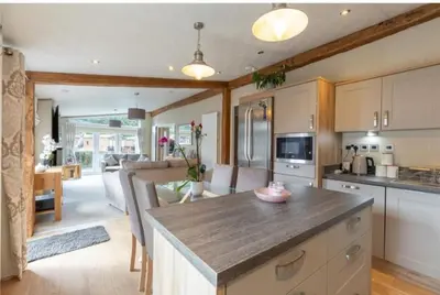 a kitchen with a large island in the middle of a room at Loubet Extra Large Lodge in Auchterarder