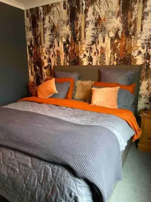a bedroom with a bed with an orange blanket at Ultra Stylish furnished Home in Edinburgh in Edinburgh