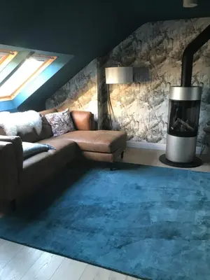 a living room with a couch and a fireplace at Ultra Stylish furnished Home in Edinburgh in Edinburgh