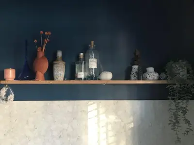 a shelf with a bunch of bottles on it at Ultra Stylish furnished Home in Edinburgh in Edinburgh