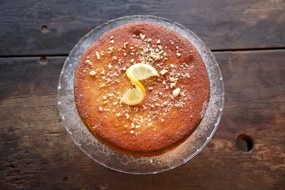 a cake with a letter s on top of a wooden table at MHOR 84 in Kingshouse