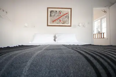 a white room with a bed and a picture on the wall at MHOR 84 in Kingshouse