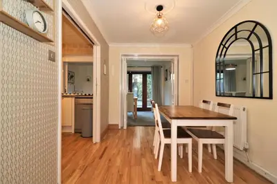 a dining room and kitchen with a table and chairs at Signature - Shield House in Scotstoun