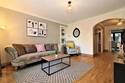 a living room with a couch and a table at Signature - Shield House in Scotstoun