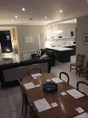 a living room with a table and a couch at Tarbert large, bright, 4 bedroom flat with harbour views in Tarbert