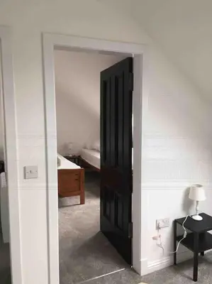 an open door to a bedroom with a bed at Tarbert large, bright, 4 bedroom flat with harbour views in Tarbert
