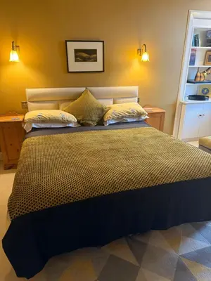 a bedroom with a large bed with two pillows at Moorlands in Helensburgh