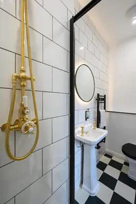 a bathroom with a sink and a mirror at Queen Charlotte Guesthouse in Edinburgh
