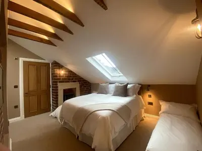 a bedroom with a large white bed and a skylight at Ashton View in Glasgow