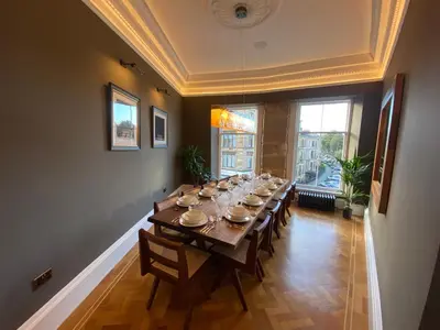 a large dining room with a long table with chairs at Ashton View in Glasgow