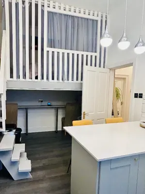 a kitchen with a white counter and a table at Glasgow Center/West End Apartment in Glasgow