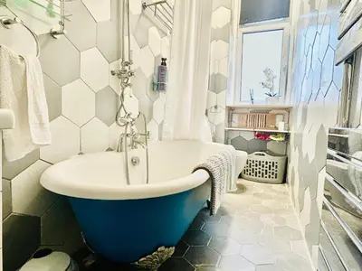a bathroom with a tub and a sink at Glasgow Center/West End Apartment in Glasgow