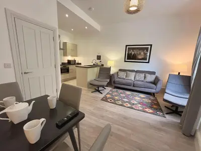 a living room with a couch and a table at King’s stable 2 rooms in Edinburgh