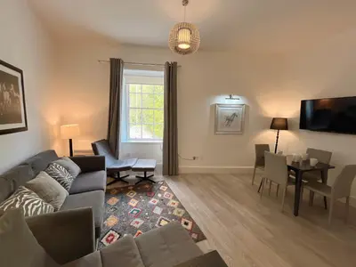 a living room with a couch and a table at King’s stable 2 rooms in Edinburgh