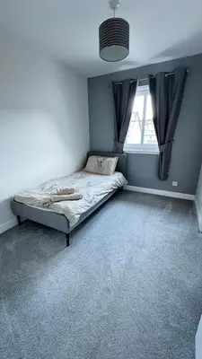 a bedroom with a bed and a window at 6 Tobar Oisinn in Oban