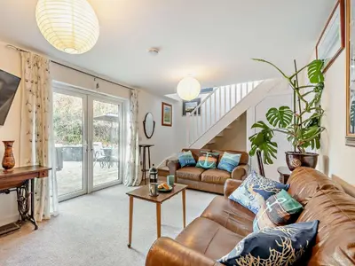 a living room with a couch and a table at 1 Bed in Inveraray 91310 in Crarae