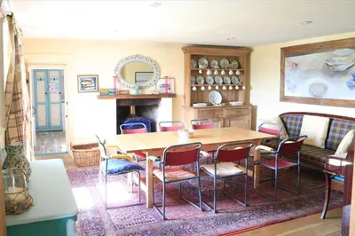 a dining room with a wooden table and chairs at Old Ferry House in Auchnacraig