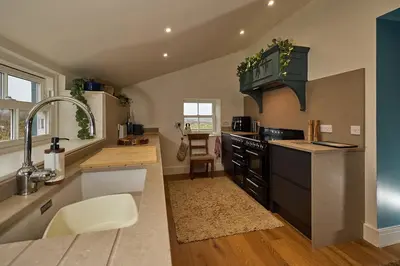 a kitchen with a sink and a stove top oven at ISLE OF GIGHA FARM HOUSE in Isle of Gigha