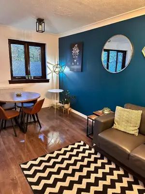 a living room with a couch and a table at BrightCentral Apartment With Parking in Glasgow