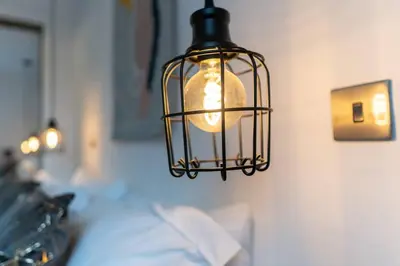 a cage light hanging from a wall at Stylish City Pad with Free Private Parking in Glasgow