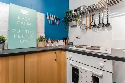 a kitchen with a stove and a counter top at Traditional 1-Bed Flat in Southside (Hampden/Shawlands) in Glasgow