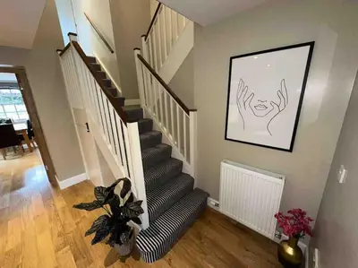 a living room with a staircase with a plant at The Gate House - 3 Bed & Parking in Edinburgh