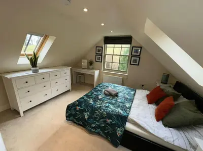 a bedroom with a bed and a dresser and window at The Gate House - 3 Bed & Parking in Edinburgh