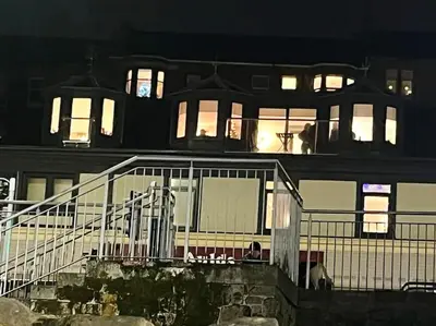 a large building with lights on in the night at Waverley Apartments, The Wheelhouse in Gourock